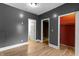 Bedroom featuring vinyl flooring and neutral walls, with multiple doors leading to other rooms at 3636 Crescent Ave, Indianapolis, IN 46208