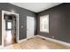 This bedroom features modern gray walls, light hardwood floors, and natural light from a window at 3636 Crescent Ave, Indianapolis, IN 46208