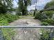 Chain link fence with gated access to the back driveway, allowing parking behind the home at 3636 Crescent Ave, Indianapolis, IN 46208
