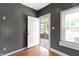 The front door opens into a small entryway with dark grey walls and vinyl wood flooring at 3636 Crescent Ave, Indianapolis, IN 46208