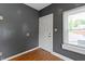 Small entryway with grey walls, vinyl flooring, a window, and a white door at 3636 Crescent Ave, Indianapolis, IN 46208