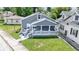 Gray home with a covered porch and stone accents on a well-maintained lawn at 3636 Crescent Ave, Indianapolis, IN 46208