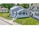Gray two-story home with covered porch, stone accents, and well-maintained lawn at 3636 Crescent Ave, Indianapolis, IN 46208
