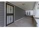 This shows a close-up of the front door with iron security details, as well as the covered porch at 3636 Crescent Ave, Indianapolis, IN 46208