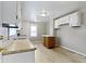Bright kitchen featuring a center island, light wood floor, and white cabinets at 3636 Crescent Ave, Indianapolis, IN 46208
