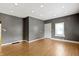 This is the living room with wood-look flooring, grey walls, and recessed ceiling lights at 3636 Crescent Ave, Indianapolis, IN 46208