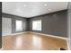 Living room with grey walls, vinyl flooring, recessed lighting, and two windows for natural light at 3636 Crescent Ave, Indianapolis, IN 46208
