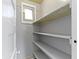 A simple shelved pantry offers convenient storage space off the kitchen at 3636 Crescent Ave, Indianapolis, IN 46208