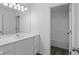 Bathroom featuring double vanity, a large mirror, and an open doorway at 3931 Wren Dr, Brownsburg, IN 46112