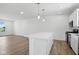 Bright kitchen featuring white cabinetry, a center island, and modern pendant lighting at 3931 Wren Dr, Brownsburg, IN 46112