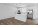 Kitchen with white cabinets, stainless steel appliances, and a center island for casual dining at 3931 Wren Dr, Brownsburg, IN 46112
