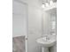 Bright powder room with pedestal sink, large mirror, and open doorway at 3931 Wren Dr, Brownsburg, IN 46112