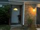 Charming townhouse front door with brick facade, well-lit entrance, and lush greenery at 3984 Braddock Rd, Indianapolis, IN 46268