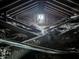 Attic featuring exposed beams, insulation, and natural light from a window at 409 Parkway St, Whiteland, IN 46184