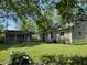The backyard features a lush lawn and several buildings, great for outdoor activities and relaxation at 409 Parkway St, Whiteland, IN 46184