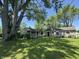 The backyard features a lush lawn and several buildings, great for outdoor activities and relaxation at 409 Parkway St, Whiteland, IN 46184