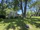 The backyard features a lush lawn and a detached garage, great for outdoor activities and relaxation at 409 Parkway St, Whiteland, IN 46184