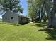 The backyard features a lush lawn and well-maintained homes, great for outdoor activities and relaxation at 409 Parkway St, Whiteland, IN 46184