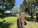 The backyard features a lush lawn and a detached garage, great for outdoor activities and relaxation at 409 Parkway St, Whiteland, IN 46184