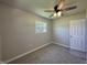 Neutral bedroom featuring plush carpet, double windows, and ceiling fan at 409 Parkway St, Whiteland, IN 46184