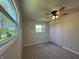 This bedroom features neutral carpeting, a ceiling fan, and a closet at 409 Parkway St, Whiteland, IN 46184