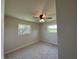 This bedroom has neutral carpeting, a ceiling fan, and two windows with a view at 409 Parkway St, Whiteland, IN 46184