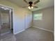 Neutral bedroom with ceiling fan, closet with folding doors, and bright double windows at 409 Parkway St, Whiteland, IN 46184