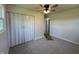 Bright bedroom with neutral walls, ceiling fan, and closet with folding doors at 409 Parkway St, Whiteland, IN 46184