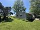 Charming home exterior with well-manicured lawn, mature trees, and cozy curb appeal at 409 Parkway St, Whiteland, IN 46184