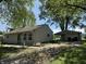 Cozy home featuring a carport, well-kept lawn, and beautiful landscaping, creating an inviting and charming outdoor space at 409 Parkway St, Whiteland, IN 46184