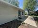 Side view of home with a concrete walkway, well-manicured yard, and inviting front door; outdoor living at its finest at 409 Parkway St, Whiteland, IN 46184