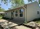 Side view of home with a concrete walkway, well-manicured yard, and welcoming front door; perfect for outdoor enjoyment at 409 Parkway St, Whiteland, IN 46184
