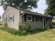 Side view of a house featuring durable siding and ample natural light; perfect for potential renovations at 409 Parkway St, Whiteland, IN 46184
