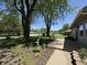 Large trees and a lush green lawn frame the home, creating a serene and picturesque outdoor space to enjoy at 409 Parkway St, Whiteland, IN 46184