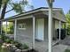 This covered patio features lovely garden boxes and a door to the right, great for outdoor entertaining at 409 Parkway St, Whiteland, IN 46184