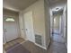 Inviting hallway with fresh paint, multiple doors, and new flooring. Making for a well maintained space at 409 Parkway St, Whiteland, IN 46184