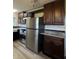 This updated kitchen is equipped with stainless steel appliances, dark cabinets, and light countertops at 409 Parkway St, Whiteland, IN 46184