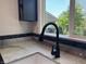 A sleek, modern kitchen faucet complements the sink and countertop at 409 Parkway St, Whiteland, IN 46184