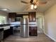 Open floorplan featuring a beautifully updated kitchen with stainless steel appliances and dark cabinetry at 409 Parkway St, Whiteland, IN 46184