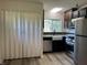 This spacious kitchen is equipped with stainless steel appliances, dark cabinets, and light countertops at 409 Parkway St, Whiteland, IN 46184