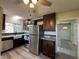 Open floorplan featuring a beautifully updated kitchen with stainless steel appliances and dark cabinetry at 409 Parkway St, Whiteland, IN 46184