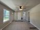 Bright living room with new flooring, ceiling fan, and large windows offering a welcoming and airy atmosphere at 409 Parkway St, Whiteland, IN 46184