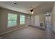 Sunlit living room with new flooring, large windows, and ceiling fan. Making the perfect space to relax in at 409 Parkway St, Whiteland, IN 46184
