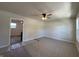 Spacious living room with neutral walls, ceiling fan, and bright windows at 409 Parkway St, Whiteland, IN 46184