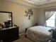 Cozy bedroom with plush carpet, a large dresser, and a unique tree sculpture wall decoration at 4920 E Daisy Ln, Mooresville, IN 46158