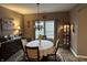 Elegant dining room featuring a chandelier, buffet, and a round dining table with seating at 4920 E Daisy Ln, Mooresville, IN 46158