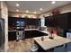 Spacious kitchen featuring dark cabinets, granite countertops, and stainless steel appliances at 4920 E Daisy Ln, Mooresville, IN 46158