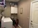 Well-equipped laundry room with washer, dryer, and shelving, offering ample storage space at 4920 E Daisy Ln, Mooresville, IN 46158