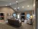 Spacious living room featuring a vaulted ceiling, cozy fireplace, and comfortable seating area at 4920 E Daisy Ln, Mooresville, IN 46158