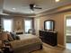 Serene bedroom featuring tray ceilings, carpet floors, fireplace, and ample space at 4920 E Daisy Ln, Mooresville, IN 46158
